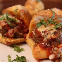 Meatball Sliders · Four sliders topped with marinara sauce, melted mozzarella and basil. Baked on our own passi...