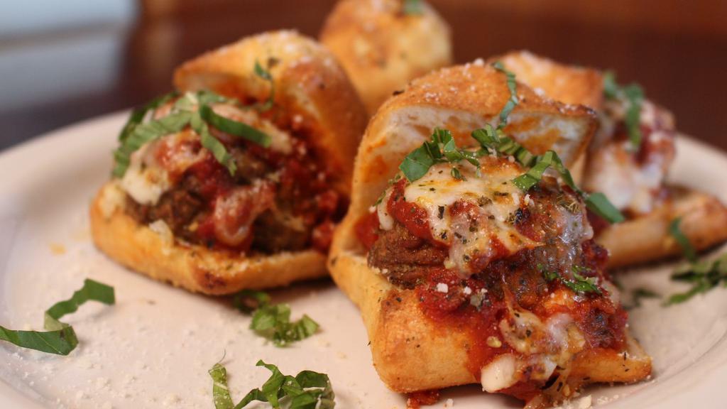 Meatball Sliders · Four sliders topped with marinara sauce, melted mozzarella and basil. Baked on our own passion bread.