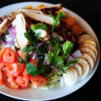 Large Cobb Salad · Breaded chicken, roma tomatoes, bacon, eggs, red onions, cheddar - served with choice of dre...