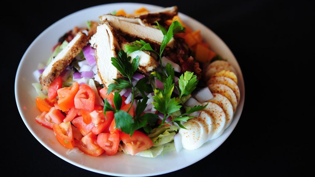 Small Cobb Salad · Breaded chicken, roma tomatoes, bacon, eggs, red onions, cheddar - served with choice of dressing.