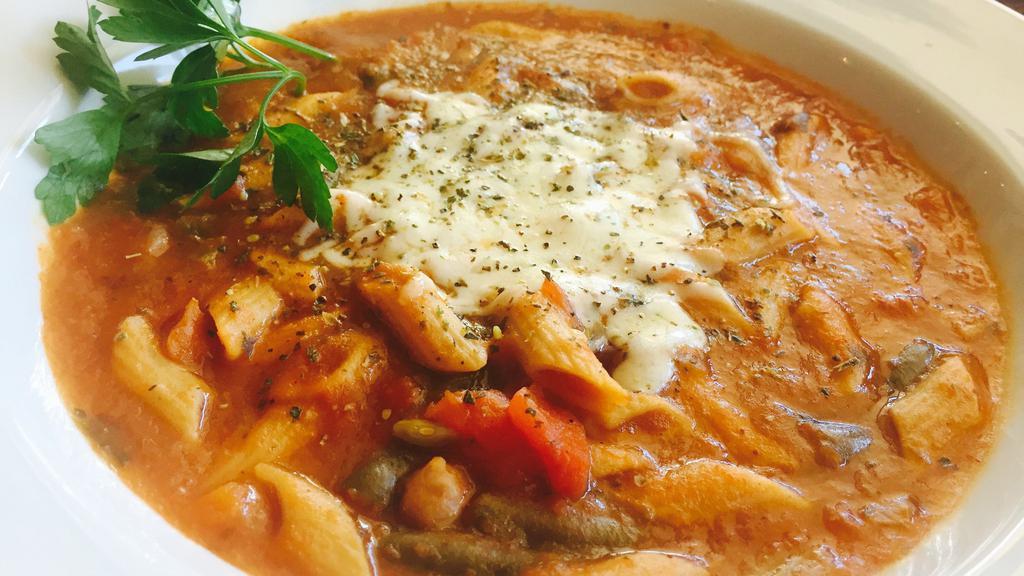 Bowl Baked Minestrone · Topped with garlic cheese bread and melted mozzarella.