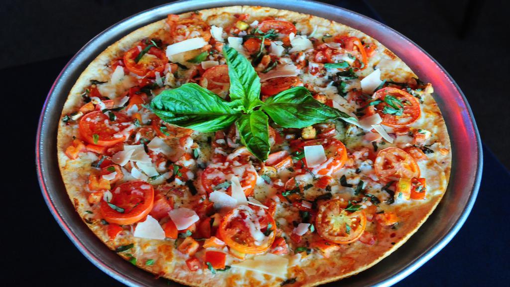 Classic Margherita Pizza · Garlic butter, Roma tomatoes, onions, fresh basil, roasted garlic, pecorino, balsamic vinegar.