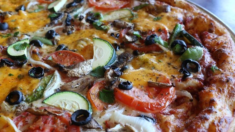 Primavera Pizza · Roma tomatoes, mushrooms, mixed bell peppers, onions, zucchini, black olives, cheddar.