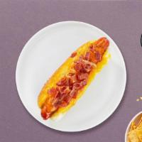 Blt Blitz Vegan Dog · Vegan hot dog topped with bacon, lettuce, tomato, and vegan mayo on a toasted hot dog bun.