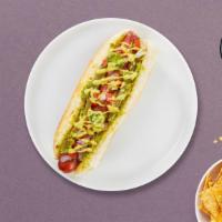 Ain'T It Avocado Vegan Dog · Vegan hot dog topped with avocado, tomato, jalapeño, and mayo on a toasted hot dog bun.