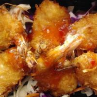 Coconut Shrimp · Tiger shrimp dipped in coconut batter and shredded coconut served with Thai sweet chili sauc...