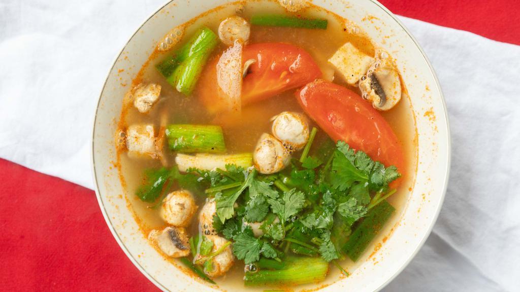 Tom Yum Soup · Lemongrass based soup with cilantro, kaffir lime leaves, mushrooms, onion and tomato.