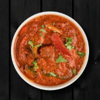 Vindalho Chicken · Boneless morsels of chicken, slow cooked in a hot and tangy traditional red 'rechado' masala.