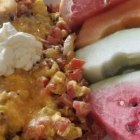Northshore Scramble · Three Eggs scrambled with Bacon, Tomatoes, Grilled Onions, Jack & Cheddar Cheese Topped with...