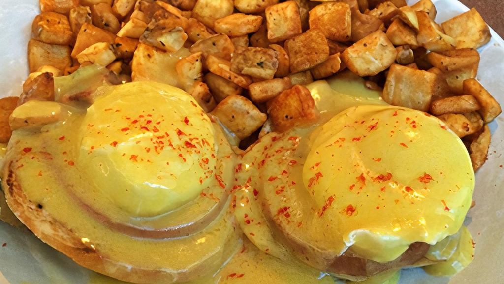 Eggs Benedict · A Grilled English Muffin, Canadian Bacon and two Poached Eggs, smothered in our Hollandaise Sauce