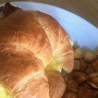 Cracked Croissant · Croissant sandwich with Eggs,  choice of Meat, Cheddar/Jack Cheese mix and choice of side