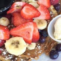Croissant French Toast · A Croissant dipped in French Toast batter and served with Fresh Seasonal Berries, Bananas, a...