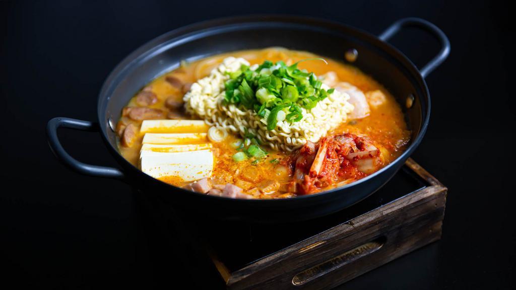 Boodae Jjigae (부대찌개) · Spicy soup with kimchi, ham, bacon, baked bean and ramen