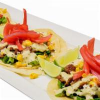Asada Street Tacos · Soft corn tortillas, grilled carne asada, cilantro, shedded lettuce, topped with roasted cor...