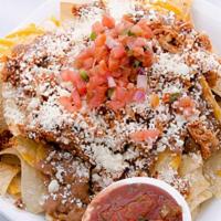 Chipotle Chicken Nachos · Layers of freshly made white corn tortilla chips, cheddar and pepperjack cheeses topped with...