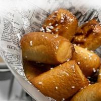 Pretzel Bites · A basket of warm, oven baked mini pretzels. Served with Cheddar cheese sauce, house made bee...
