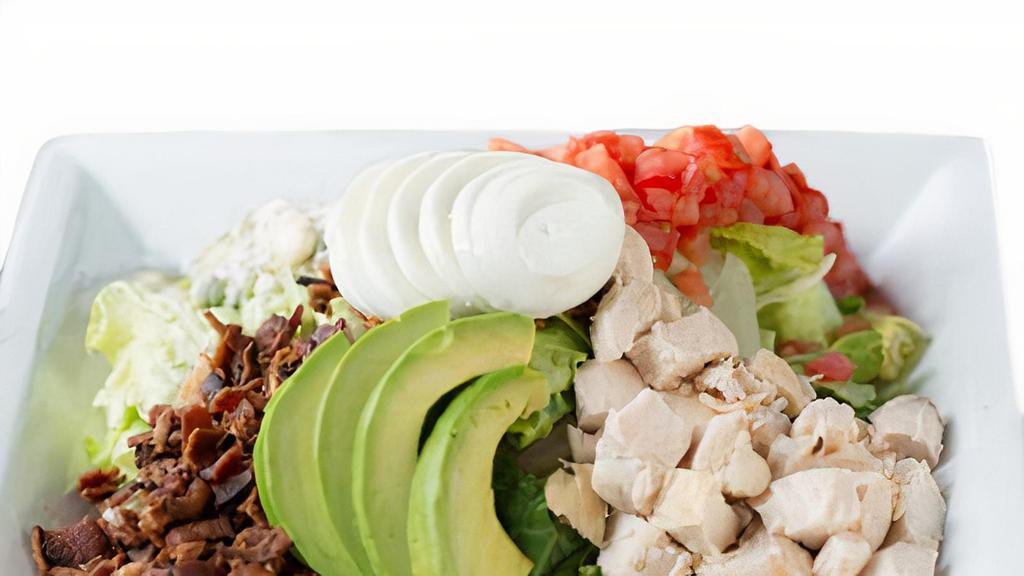 Chef'S Chopped Cobb · Chilled romaine lettuce topped with diced chicken, applewood smoked bacon, bleu cheese crumbles, sliced hard boiled eggs, avocado, and diced roma tomatoes.