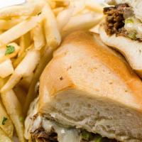 South Philly Cheese Steak · Shaved sirloin grilled with onions, peppers, and smothered with provolone cheese, served on ...