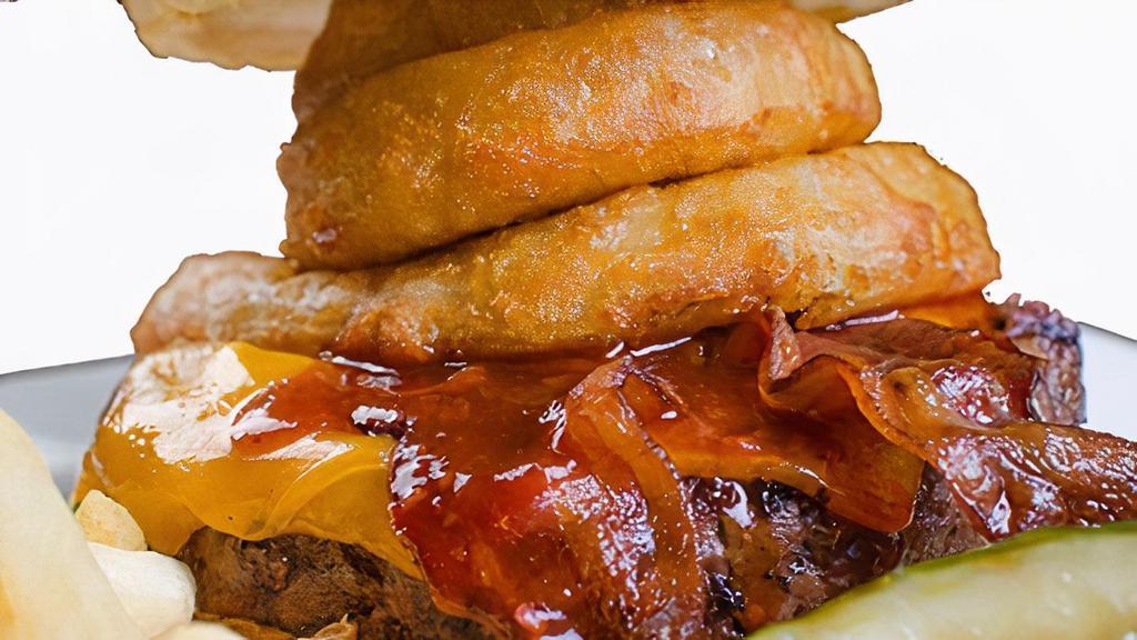 Western Bacon Burger · Fresh grilled ground chuck patty, topped with our house BBQ sauce, applewood bacon, cheddar cheese and onion rings