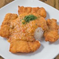 Smothered Catfish · Battered catfish blanket with étouffée served with rice.