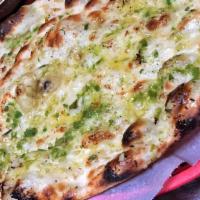 Spicy Chili Garlic Naan · Freshly baked flatbread topped with green chili, Cilantro & garlic. Vegetarian.