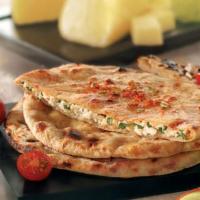 Paneer Paratha · Whole wheat bread stuffed with cottage cheese and herbs. Vegetarian.