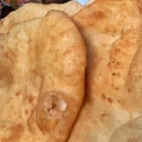 Puri (2Pcs) · Two deep-fried balloons puffed bread made with wheat flour. Vegan. Vegetarian.