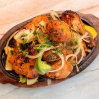 Tandoori Chicken · Marinated Chicken roasted in a clay oven with herbs and spices. Gluten-Free.