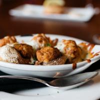Italian Sausage Stuffed Mushrooms · Smothered with fresh mozzarella cheese and baked