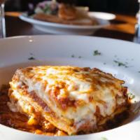 Johnnys Lasagna · Pasta, seasoned ricotta cheese, plum tomatoes, meat sauce, mozzarella