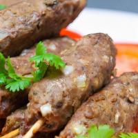Lamb Seekh Kabob · Minced lamb mixed with onion and herbs, roasted on skewers. Served with a side of white rice...