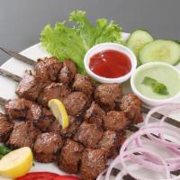 Beef Tikka Boti · Smoked beef marinated in fresh spices, prepared in a clay oven. Served with a side of white ...