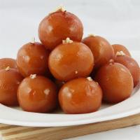 Gulab Jamun · Delicious lightly browned cheesecake balls cooked in lightly flavored sauce.