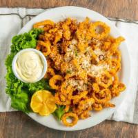 Calamari · Tender calamari tossed in seasoned flour and deep fried to a golden brown, topped with grate...
