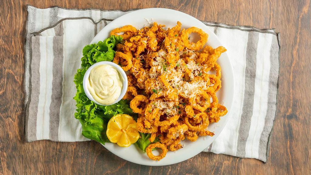 Calamari · Tender calamari tossed in seasoned flour and deep fried to a golden brown, topped with grated Asiago cheese. Served with housemade lemon aioli sauce.