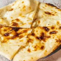 Naan · Soft dough bread baked in a charcoal oven. Baked fresh on the clay walls of tandoor oven.