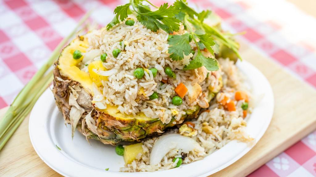 Pineapple Fried Rice · Gluten free. Fried rice with egg, pineapple, onions, green peas, carrots, and onions.