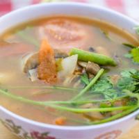 Tom Yum · Gluten free. Lemongrass soup with tomatoes, mushrooms, green onions, sweet onions, green bea...