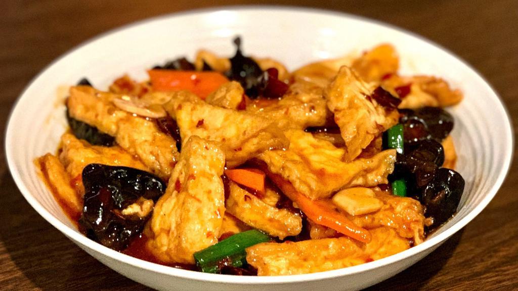 Home Style Stir Fried Tofu 家常豆腐 · Pan fried Tofu Stir fried with wood ear mushroom, carrot slices and green onion in spicy fermented bean sauce.