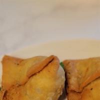 Vegetable Samosa · Crisp Pastry filled with Potato, peas, spices, and deep-fried. Vegan upon request only.