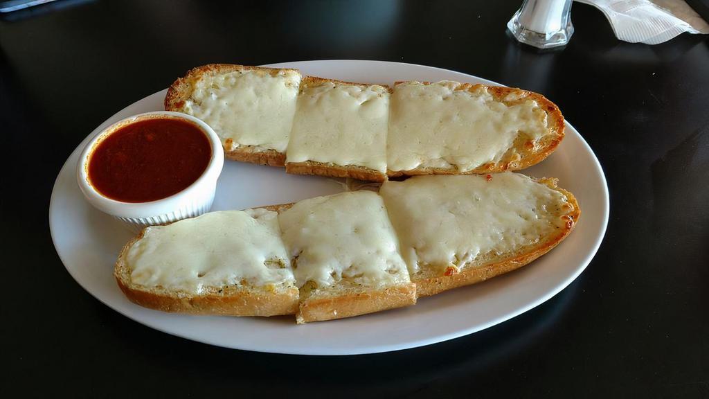 Garlic Bread With Cheese · Buttery bread that is topped with garlic and melted mozzarella cheese.