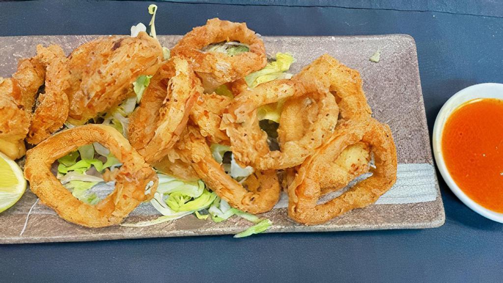 Crispy Calamari · Battered and flash fried served with lime wedge and sweet chili sauce