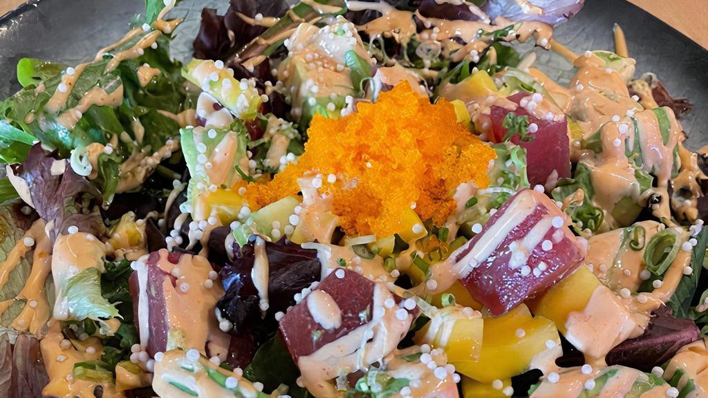 Tuna Avocado Salad · Spring mix, diced tuna, topped with rice caviar, tobiko, chives, spicy mayo, and yuzu dressing.  These items may be served raw or undercooked or contain raw or undercooked ingredients.