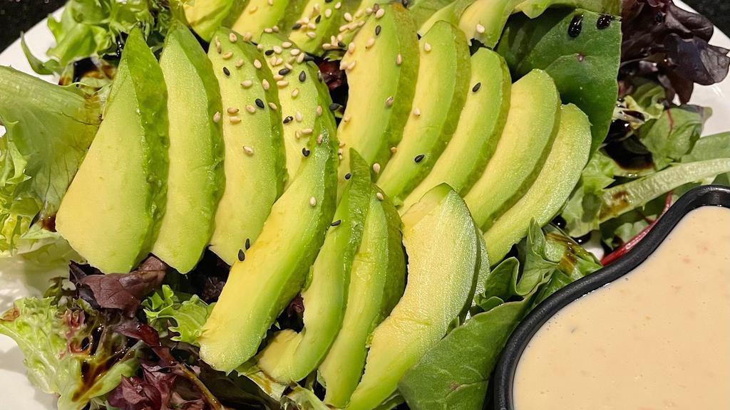 Avocado Salad · Mixed greens topped with thinly sliced avocado and sesame seed.  Served with house dressing on side.