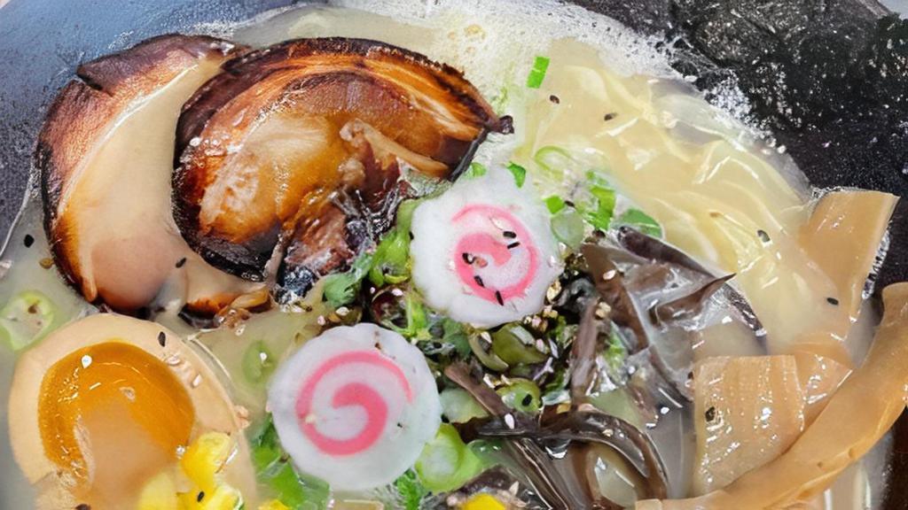 Tonkotsu Ramen · Tonkotsu salt flavor with chashu, onions with pork, egg. fish cake, corn, scallion. Bamboo shoot, wood ear, nori and black garlic oil.