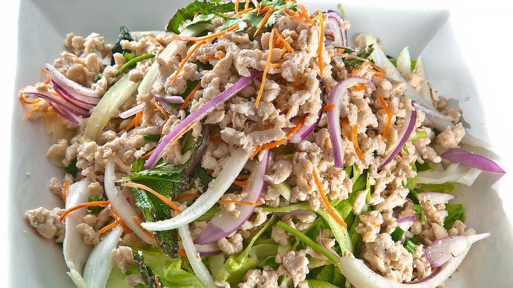 Larb Gai Salad · Ground chicken in fresh lime juice, shredded carrots, onions, cilantro and mints, served with fresh lettuce.