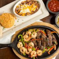 Fajitas · Mesquite marinated steak, chicken or shrimp. Served with flour tortillas and a side of sour ...