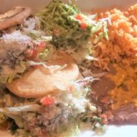 Gorditas · Two small gorditas from corn, stuffed with meat, served with beans and rice then garnished w...