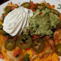 California Nachos · Fried chicken burrito, split into small pieces, topped with melted cheese, tomatoes, onions ...