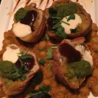 Samosa Chaat · Spiced potatoes in a crispy pastry shell, served on garbanzo beans seasoned with 'bhel' spic...